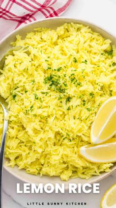 lemon rice in a white bowl with spoons