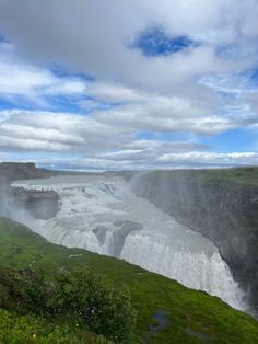 the water is flowing down the side of the waterfall