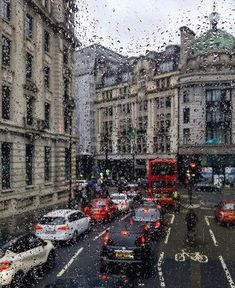 traffic is seen through the rain on a city street in london, england as it rains