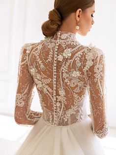 the back of a woman's wedding dress, with an intricate lace and tulle design