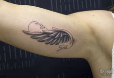 a woman's arm with an angel tattoo on the left side of her arm