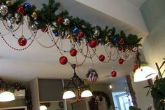 christmas decorations hanging from the ceiling in a kitchen