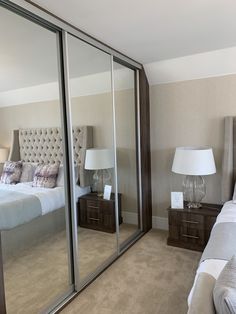 a bedroom with mirrored closet doors and a bed