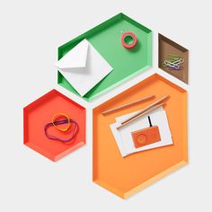 an assortment of crafting supplies including scissors, tape, and paper on a hexagonal tray