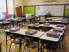 a classroom filled with lots of desks covered in cakes on top of each table