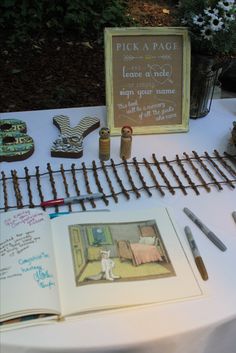 an open book sitting on top of a white table covered in writing and other items