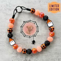 an orange and black beaded halloween bracelet with a photo of a dog on it