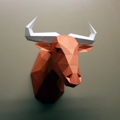 an origami bull head mounted on the wall