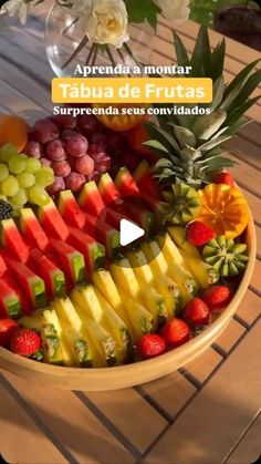 a bowl filled with fruit on top of a wooden table