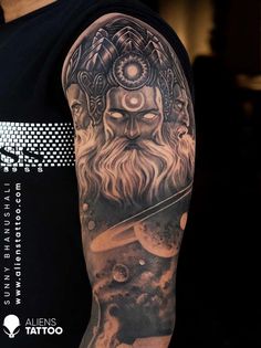 a man with a full sleeve tattoo on his arm