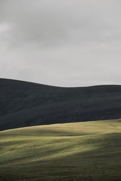 an open field with hills in the background