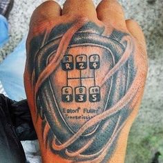 a man's foot with a tattoo on it that has a cell phone in the middle