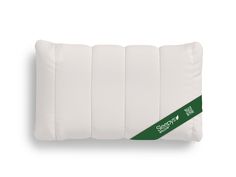 the back side of a white pillow with green ribbon around it on a white background