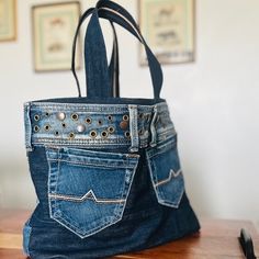 a purse made out of jeans on top of a wooden table