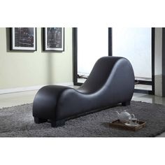 a modern lounge chair sitting on top of a gray rug