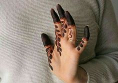 a woman's hand with hendix on it and her fingers painted brown