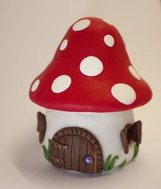 a red mushroom house with white polka dots on it