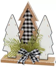 a wooden christmas tree sitting on top of a table