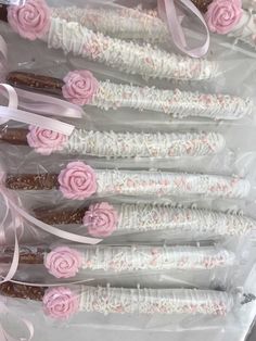 there are many candy sticks with pink roses on them