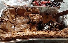 a pan filled with brownies and other desserts