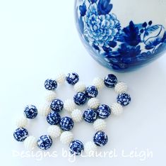 blue and white beaded beads next to a vase