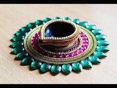 an assortment of jewelry sitting on top of a wooden table