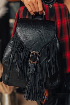 - This boho backpack is perfect for a stylish casual look! - Faux leather material - Gold hardware - Button/flap closure with faux fringe detail as well as a functional drawstring closure - A single handle on top - Two adjustable length shoulder straps - A fully lined pouch with three interior pockets Trendy Adjustable Backpack, Boho Backpack, Leather Fringe, Women Clothing Boutique, Leather Material, Online Womens Clothing, Boutique Clothing, Gold Hardware, Shoulder Straps