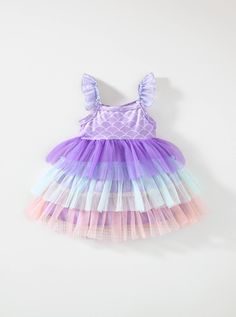 Dive into enchanting style with our Baby Girl's Mermaid Tail Pattern Color Block Mesh Layered Frilled Hem Spaghetti Strap Dress! This mesmerizing ensemble features a whimsical mermaid tail pattern combined with a delightful color block design, creating a look that's as magical as it is adorable. The mesh layered frilled hem adds an extra touch of charm, perfect for your little one's twirl-worthy moments. With adjustable spaghetti straps for a comfortable fit, this dress is ideal for any special Purple Mermaid Hem Summer Dress, Pink Mermaid Dress For Summer, Pink Mermaid Dress For Spring, Blue Summer Mermaid Dress For Dress-up, Blue Mermaid Dress For Summer Dress-up, Blue Mermaid Dress For Summer Events, Summer Mermaid Dress With Ruffles, Ruffled Mermaid Summer Dress, Purple Sleeveless Mermaid Dress For Summer