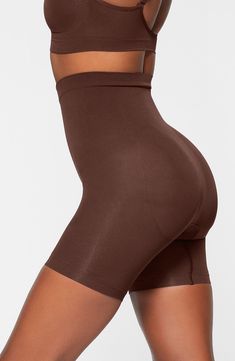 Sculpt your body's natural shape with shaping shorts that hit just above the knee with a whisper-soft and seamless design from Kim Kardashian's SKIMS. Reflecting the brand's passion for highly technical shapewear solutions for every body, this staple piece smoothes your upper legs while lifting your butt and comes in different shades to complement your skin tone. 5" regular inseam Cotton-lined gusset 82% nylon, 18% elastane Machine wash, tumble dry Made in Turkey Compressive Smoothing Mid-thigh Shapewear, Smoothing Compressive Mid-thigh Shapewear, Shapewear With Built-in Bra In Short Shape, Solid Shapewear With Built-in Bra, Short Shape, Solid Color Shapewear With Built-in Bra, Seamless Compression Shapewear, Mid-thigh Length, Seamless Compression Shapewear Mid-thigh Length, Seamless Shaping Shapewear Mid-thigh Length, Shapewear With Built-in Bra And Short Legs