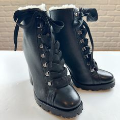 Elevate Your Winter Style With These Boots By Schutz In The Zhara Style. Plush Faux Fur Lines A Towering Lace-Up Boot Grounded By A Block Heel And Chunky Lugged Sole. Pebbled Leather And Oversized Ribbon Like Laces Add A Feminine Touch. These Boots Are New And Never Used. No Box. Color: Black Size: 7 4 1/4" Heel 5" Shaft Leather Upper/Textile Faux-Fur Lining/Rubber Sole Perfect To Pair With Jeans, Leggings Or Dresses During Cold Weather Months. Winter Platform Lace-up Booties, Winter Platform Mid-calf Boots In Faux Leather, Black High Heel Lace-up Boots For Winter, Winter Synthetic Wedge Boots With Round Toe, Winter Leather Lace-up Boots, Winter Platform Combat Boots In Faux Leather, Winter High-top Synthetic Heeled Boots, Winter Platform Lace-up Mid-calf Boots, Chic Winter Moto Boots With Reinforced Heel