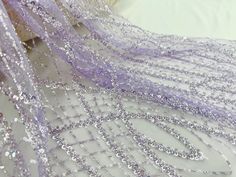 purple sequins and sheer fabric on a white surface