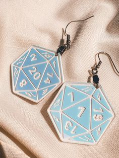 "Introducing our stunning Acrylic D20 Earrings - a must-have accessory for tabletop gaming enthusiasts and Dungeon Masters alike. These earrings are not only a fashionable statement but also a nod to your passion for the world of Dungeons & Dragons. Reflective Brilliance: Crafted from high-quality acrylic, these earrings boast a captivating reflective effect that adds a touch of enchantment to your ensemble. The engraved parts are elegantly highlighted in white, enhancing the intricate design of D20 Earrings, Dnd Jewelry, Dice Earrings, Acrylic Jewelry, Dungeons Dragons, Acrylic Jewellery, Eco Friendly Paper, Gamer Gifts, Acrylic Earrings