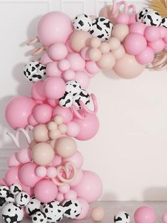 the balloon arch is decorated with pink, white and black balloons