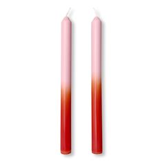 two red candles sitting next to each other