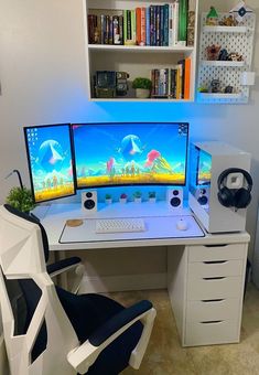 two computer monitors sitting on top of a desk in front of a book shelf filled with books