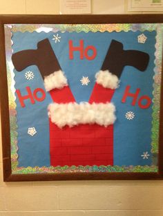 a bulletin board with santa's hat and hammers hanging on the wall above it