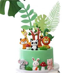 a three tiered cake decorated with animals and plants