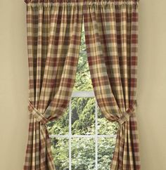 a window with plaid curtains in front of it and trees outside the window sill