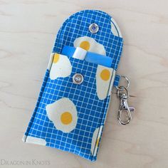 an oven mitt with eggs on it and a keychain attached to it