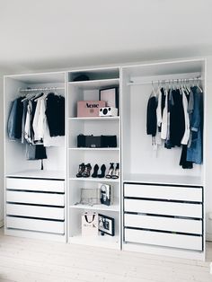 a white closet filled with lots of clothes