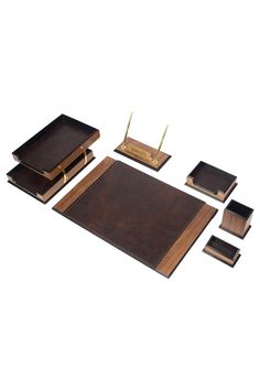 a set of five wooden desk accessories including a notebook, pen holder and two pens