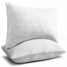 two pillows sitting side by side on top of each other in front of a white background