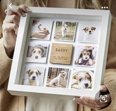 a woman holding up a white framed photo with dogs on it's side and the words buddy written in cursive