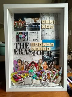 a shadow box filled with assorted items on top of a wooden table