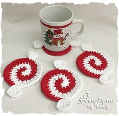 three crocheted coasters and a coffee cup holder