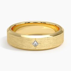 a yellow gold wedding band with a diamond in the center, on a white background