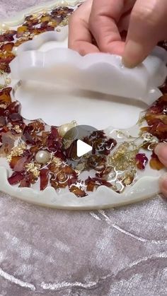 a person is making a decorative glass plate