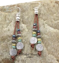 "These Southwestern boho leather dangle earrings consist of 2 strips of round leather cord accented with silver plated Tibetan style concho beads topped with picasso seed beads and a silver plated spacer bead. The leather cord is glued into silver plated cord ends. You have your choice of picasso seed beads. The multicolor is shown in the photos...turquoise, cobalt, yellow, and red picasso. CHOOSE YOUR SEED BEAD COLOR AND EARWIRES FROM THE DROP DOWN MENU. ENTER YOUR LEATHER COLOR CHOICE IN THE P Bohemian Brown Beaded Nickel-free Earrings, Nickel-free Brown Beaded Earrings For Festival, Adjustable Concho Earrings For Festival, Brown Bohemian Concho Earrings, Adjustable Southwestern Brown Earrings, Bohemian Concho Dangle Jewelry, Adjustable Brown Beaded Earrings For Festival, Bohemian Leather Dangle Jewelry, Hand Tooled Adjustable Dangle Earrings