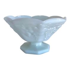 a white glass bowl sitting on top of a table