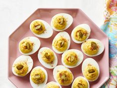 deviled eggs are arranged on a pink plate